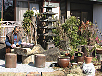 庭で素焼を点検する木村さん